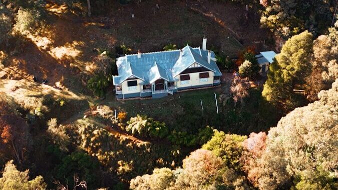an aerial view of a house surrounded by trees